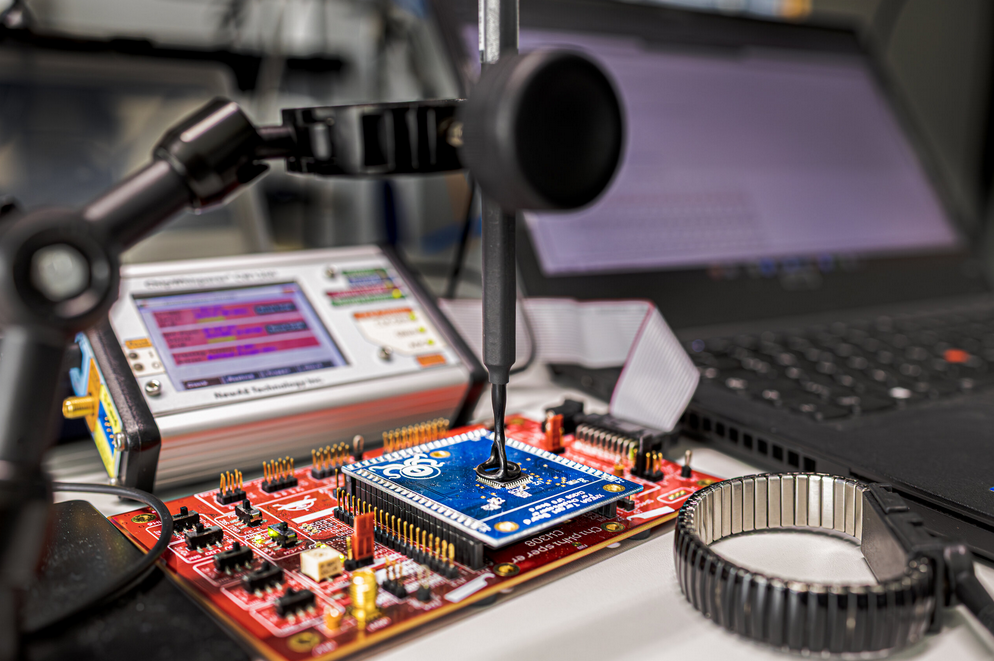 Measurement setup with a Langer EM probe on a target board